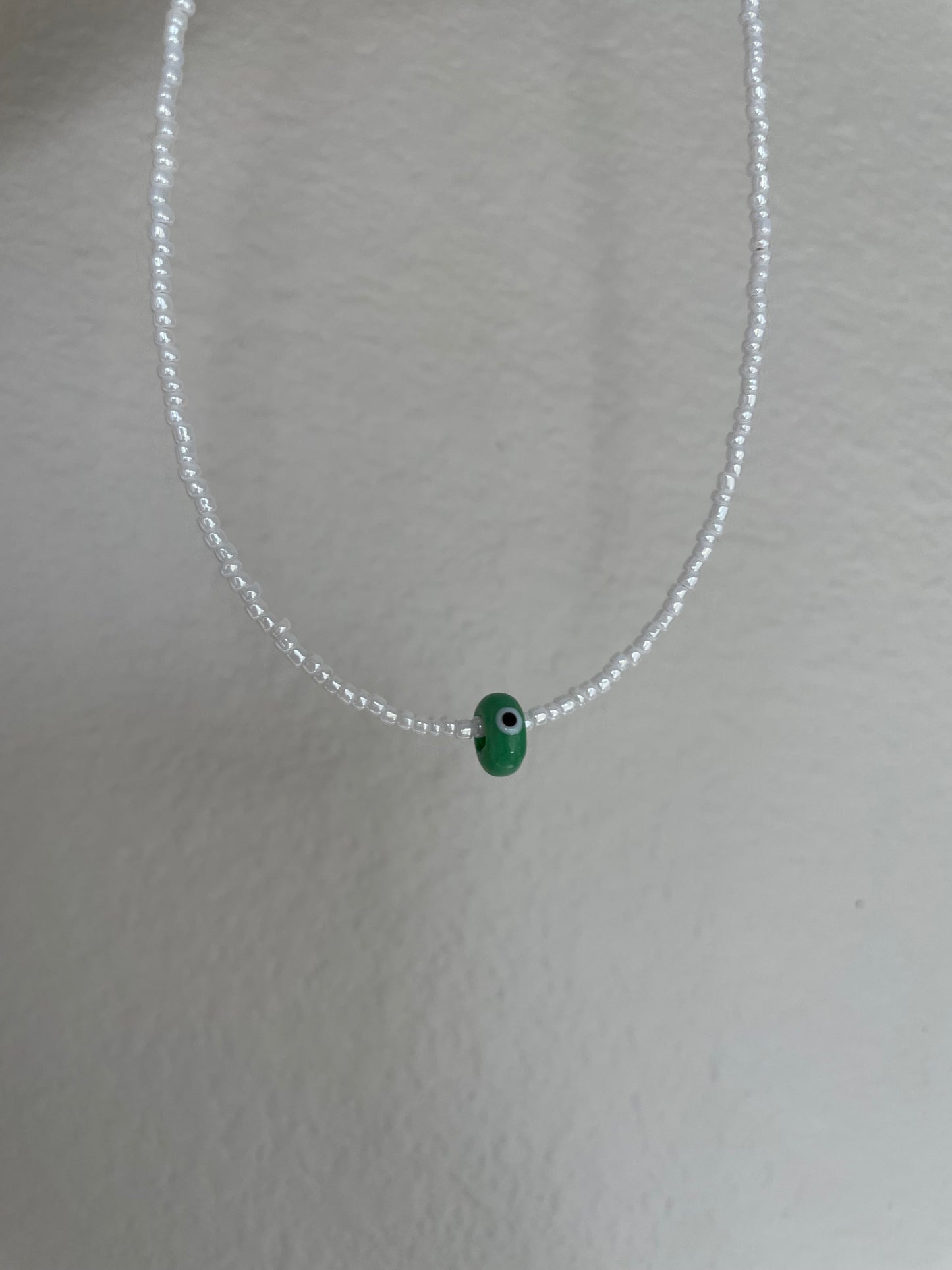 Dainty green evil eye