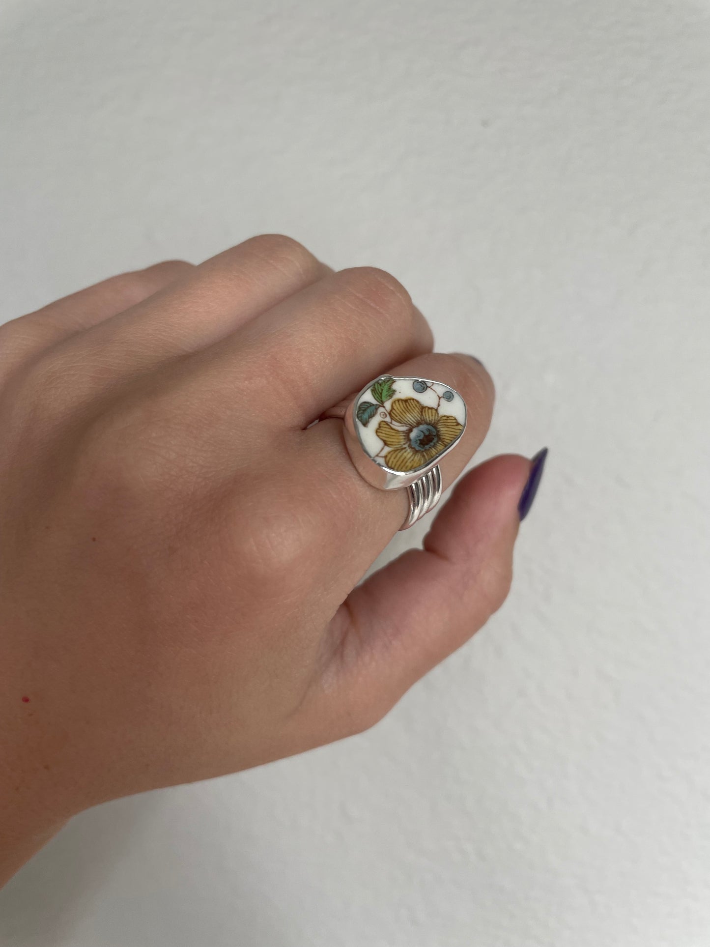 Yellow floral pottery ring (s 8.25)