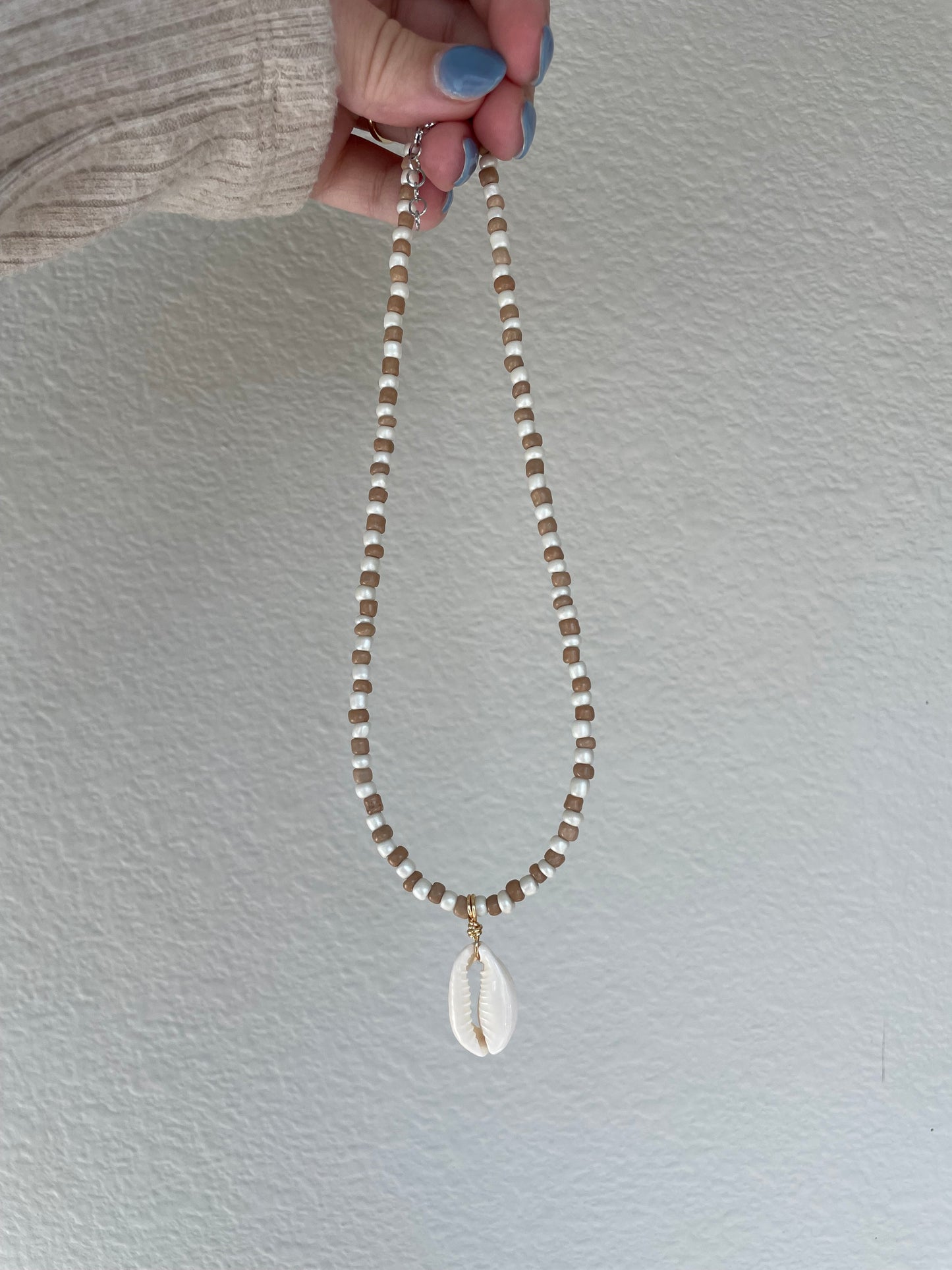 Brown and cream cowrie pendant