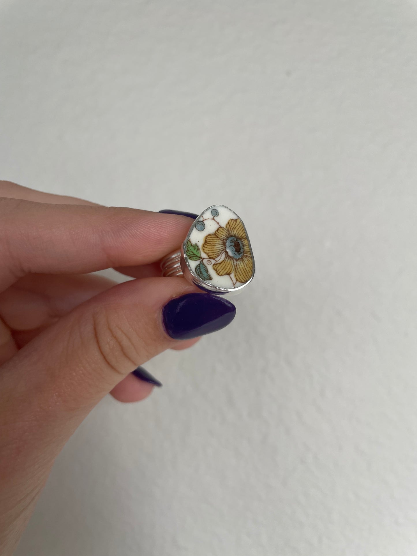 Yellow floral pottery ring (s 8.25)