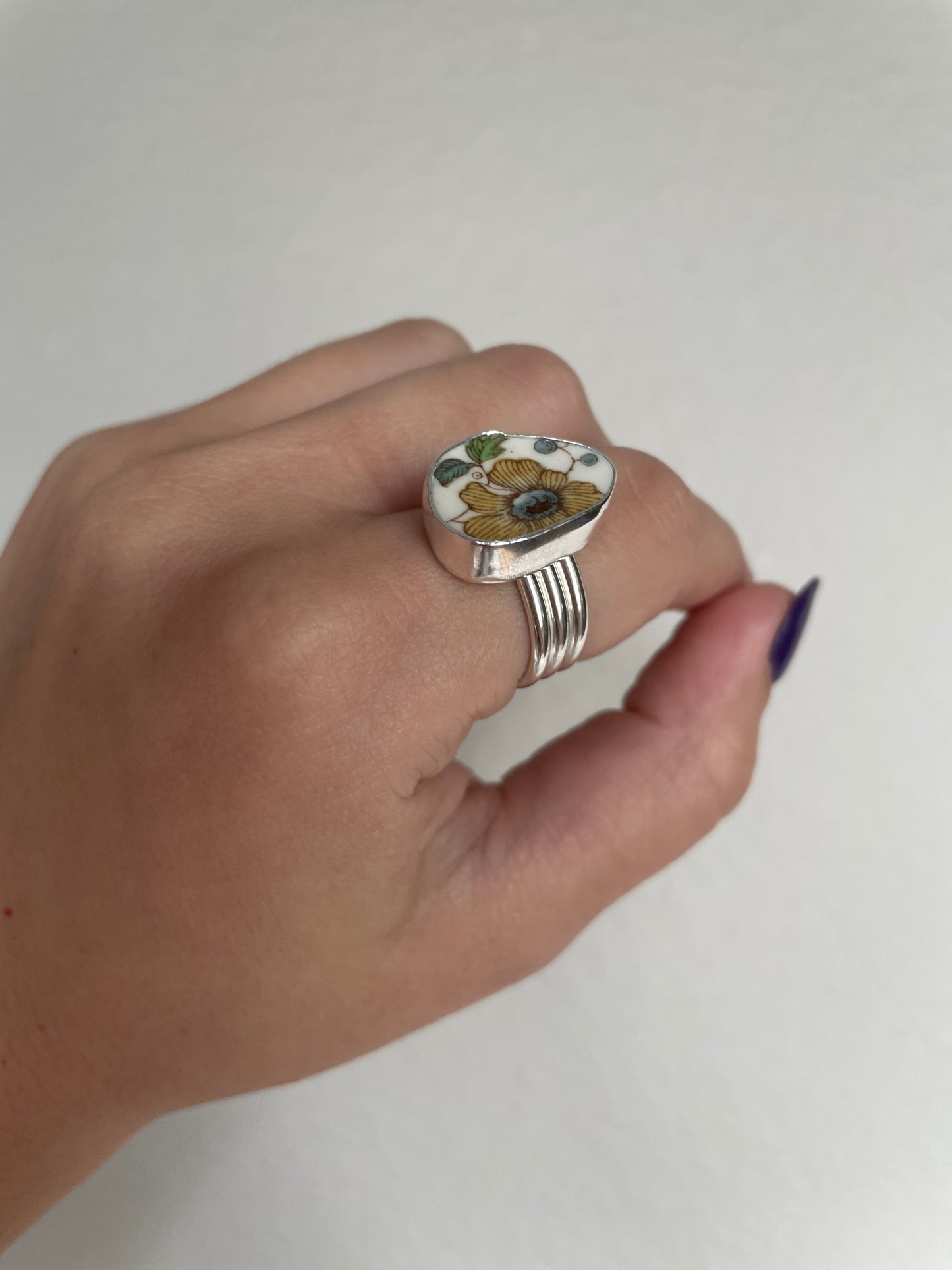 Yellow floral pottery ring (s 8.25)