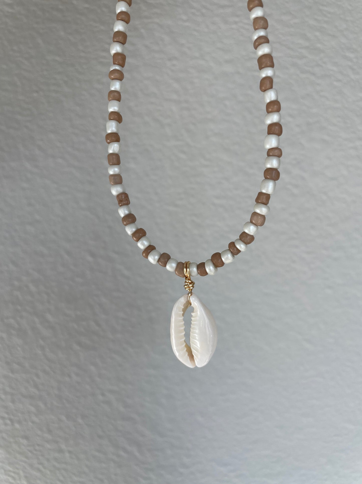 Brown and cream cowrie pendant